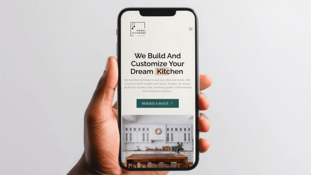 A person holding a smartphone displaying an advertisement on a website for custom kitchen design services.